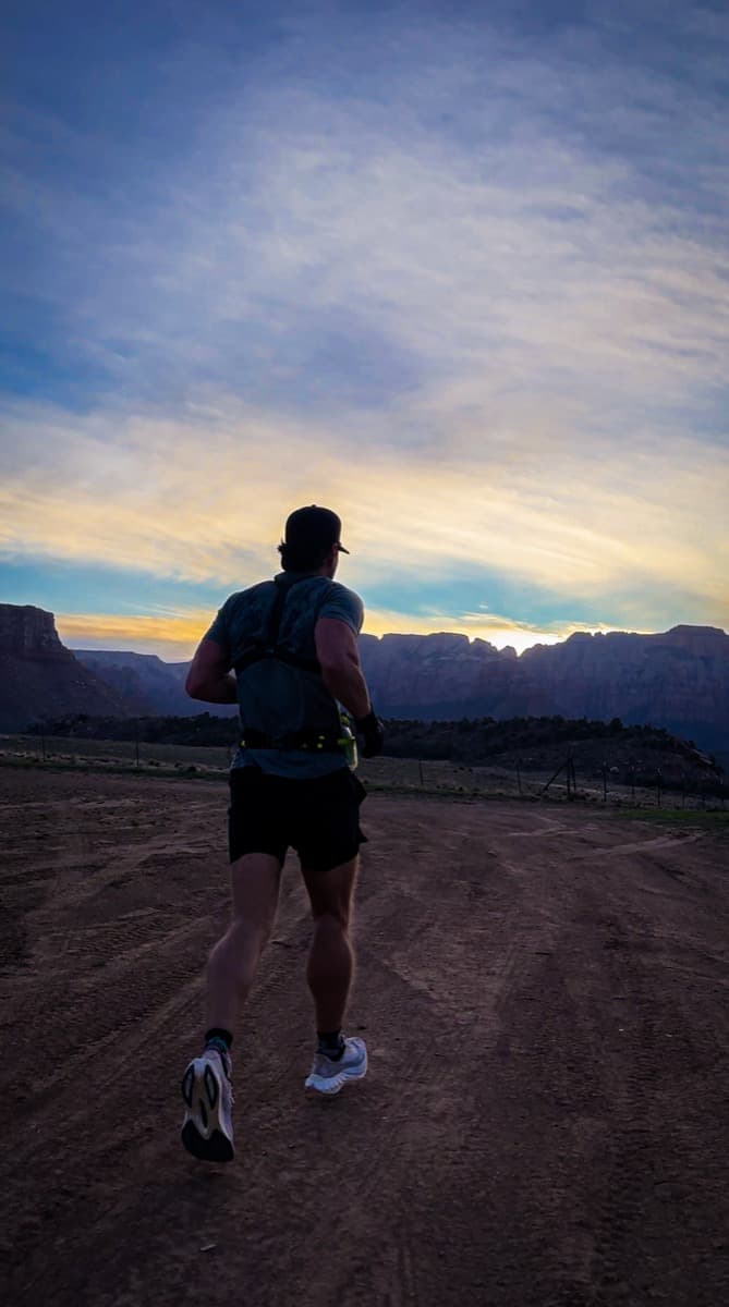 Trevor running into the sunrise above Virgin, Utah
