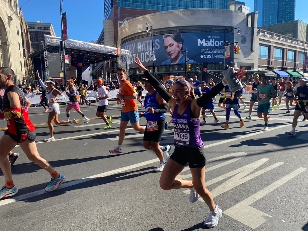 Juliana at the TCS New York City Marathon, running in purple for the Alzheimer's Association