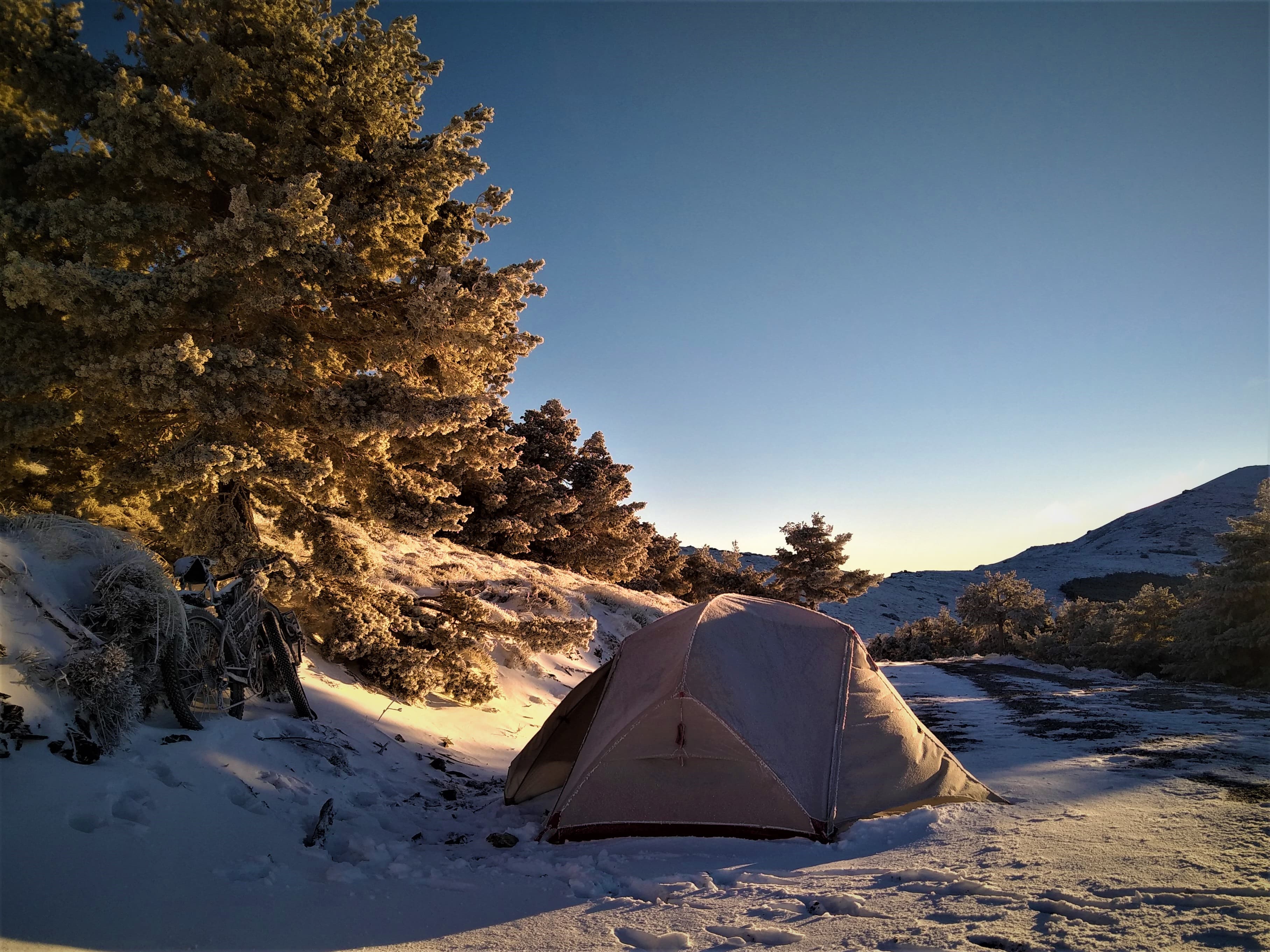 A tent at first light in the snow