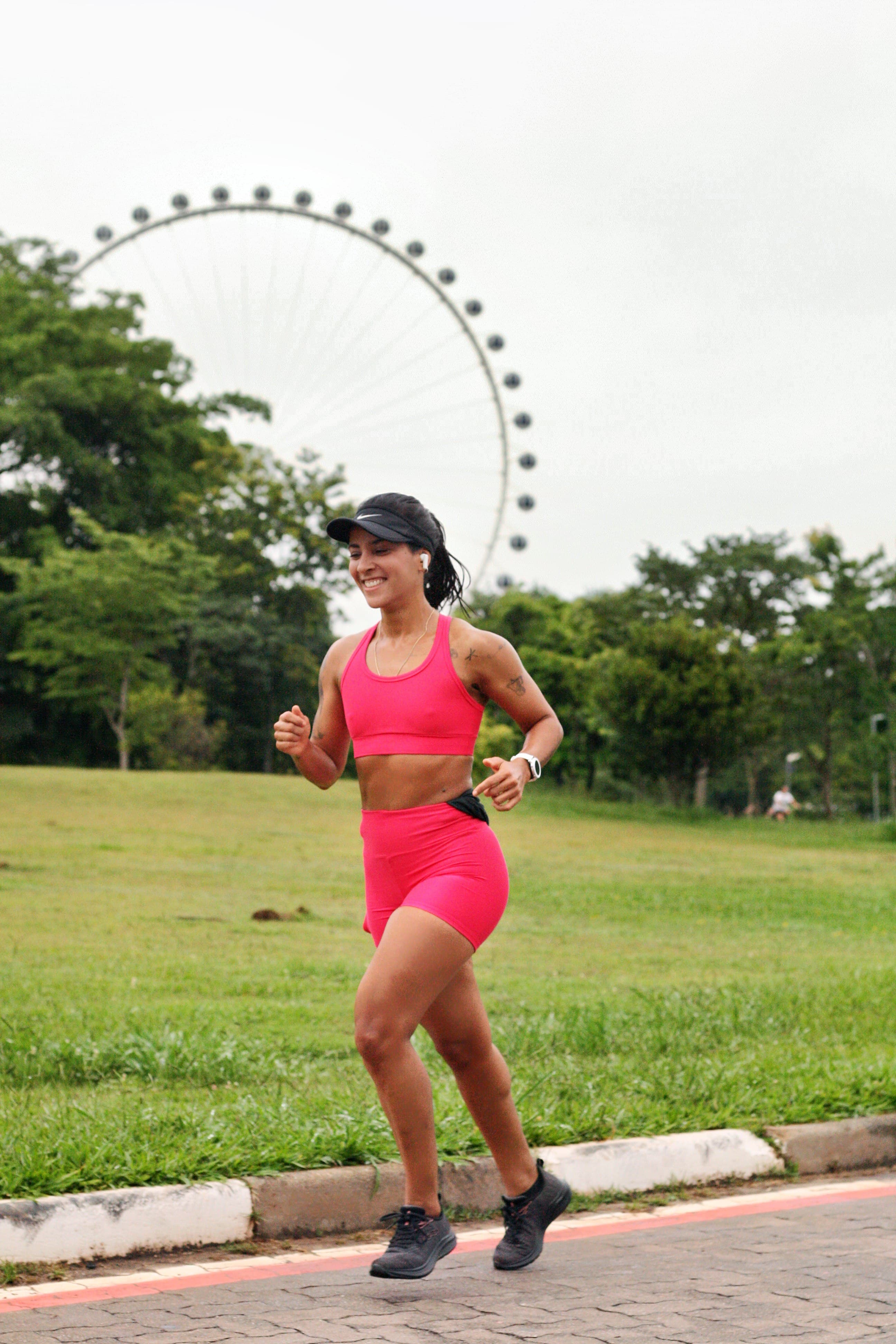 Mari on a park run in São Paulo with the Ferris wheel behind her